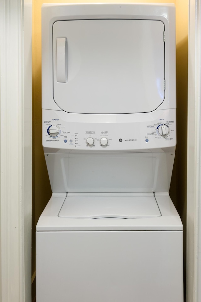 laundry area with stacked washer / drying machine