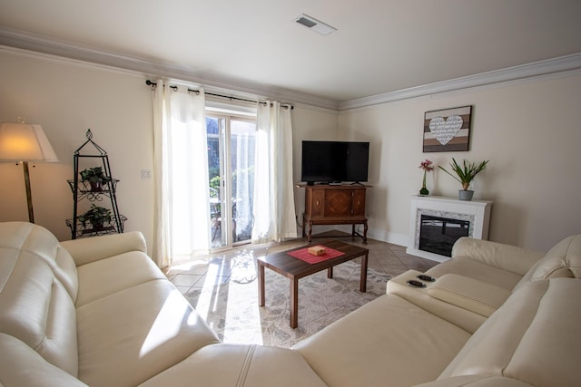 living room with a high end fireplace, ornamental molding, and light tile patterned flooring