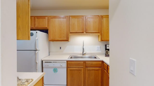 kitchen featuring sink and white appliances