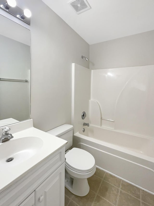 full bathroom featuring vanity, bathing tub / shower combination, toilet, and tile patterned floors