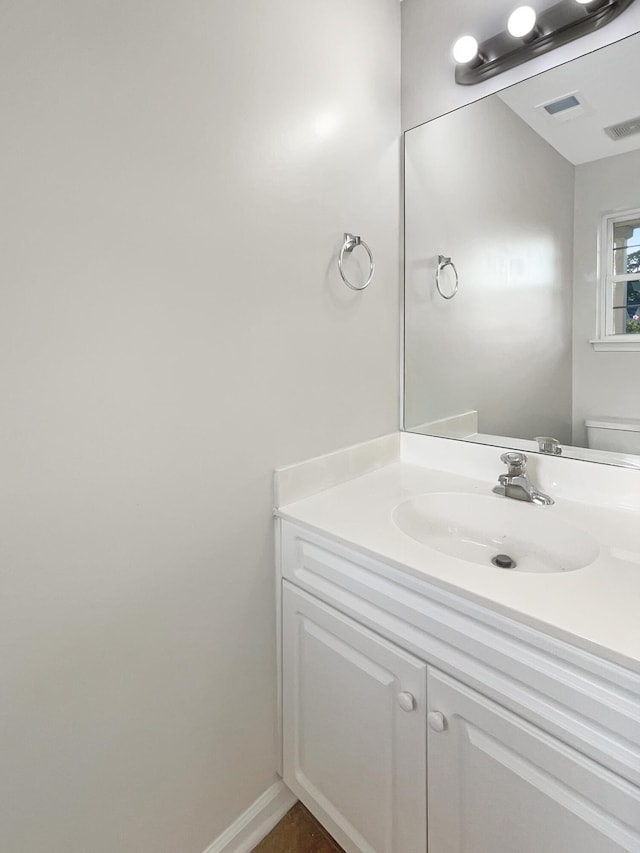 bathroom featuring vanity and toilet