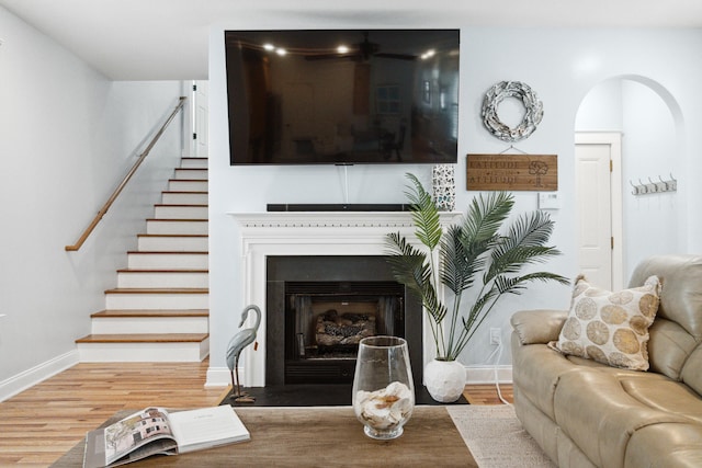 907 High Nest Ln, Charleston, SC 29412 - living room featuring stairs, wood finished floors, and a fireplace