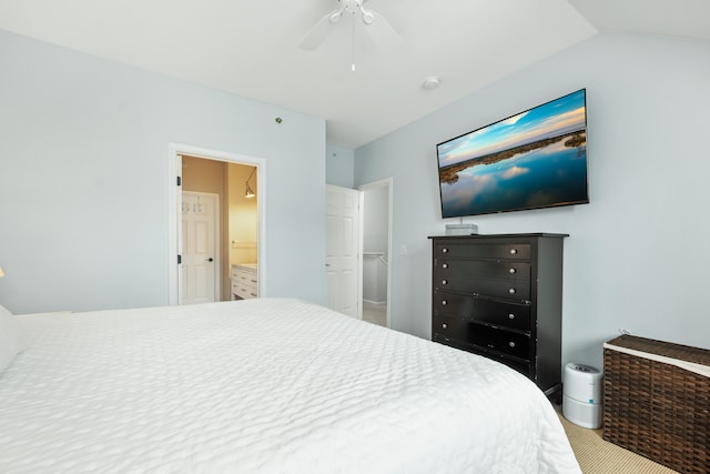 bedroom with carpet flooring, ensuite bathroom, vaulted ceiling, and ceiling fan