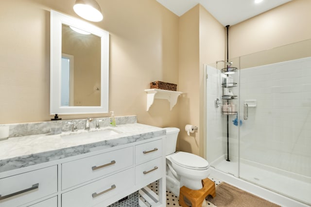 bathroom featuring vanity, toilet, and walk in shower