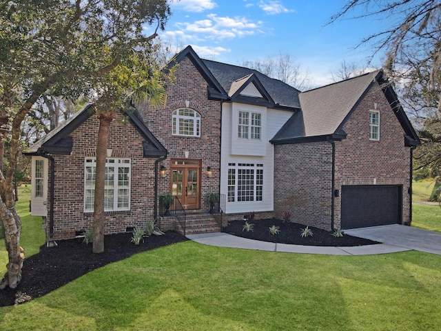 traditional-style home with an attached garage, driveway, brick siding, and a front yard