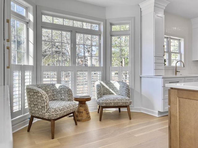 sunroom / solarium with ornate columns and a sink