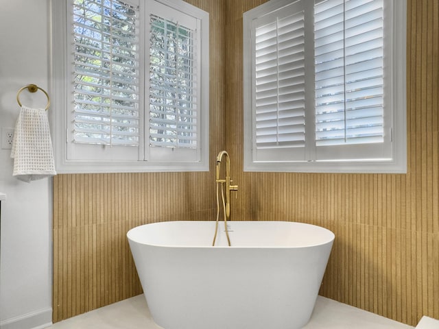 bathroom featuring a freestanding tub and a sink