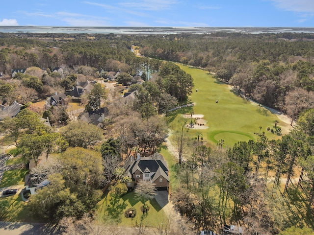 birds eye view of property featuring a forest view and golf course view