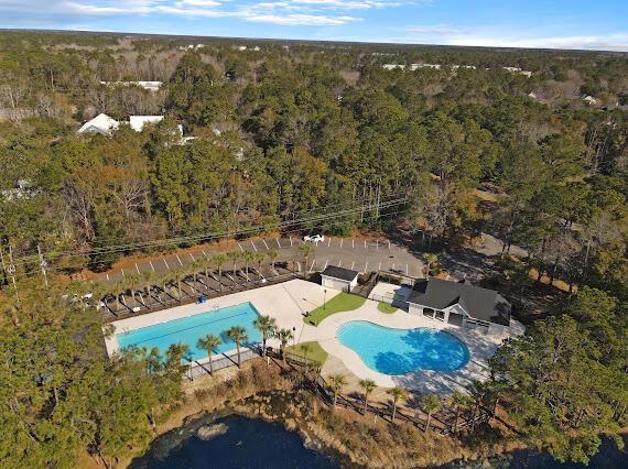 pool featuring a forest view and a patio area