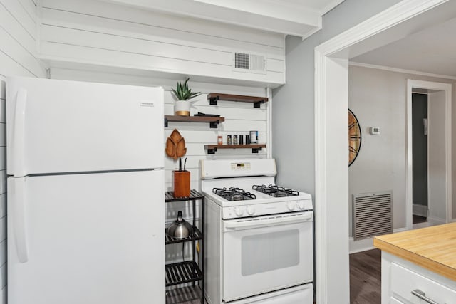 kitchen featuring hardwood / wood-style floors, white cabinets, white appliances, and ornamental molding