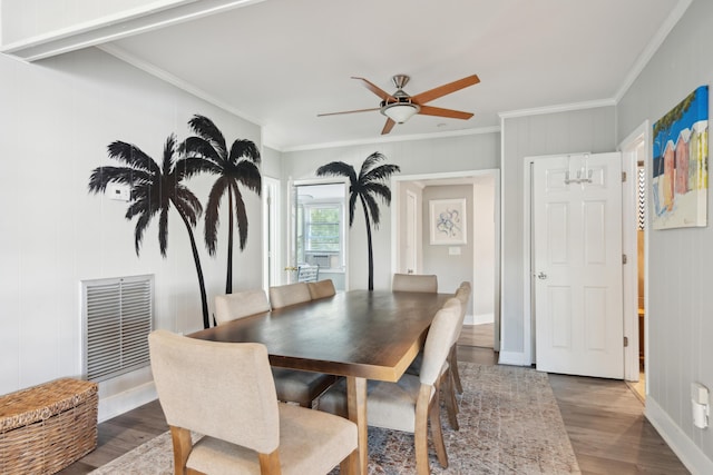 dining space with dark hardwood / wood-style floors, ceiling fan, and crown molding