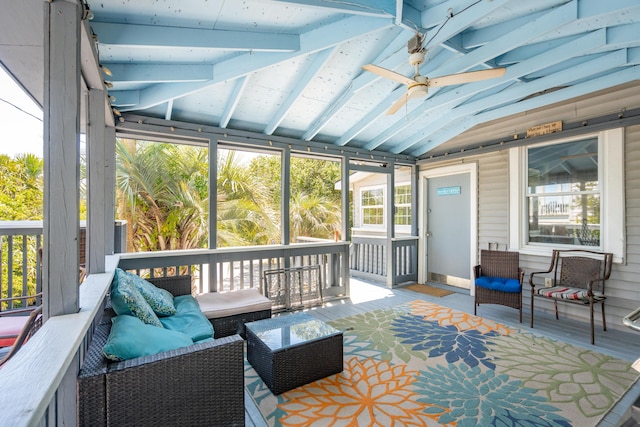 sunroom / solarium with ceiling fan and lofted ceiling with beams