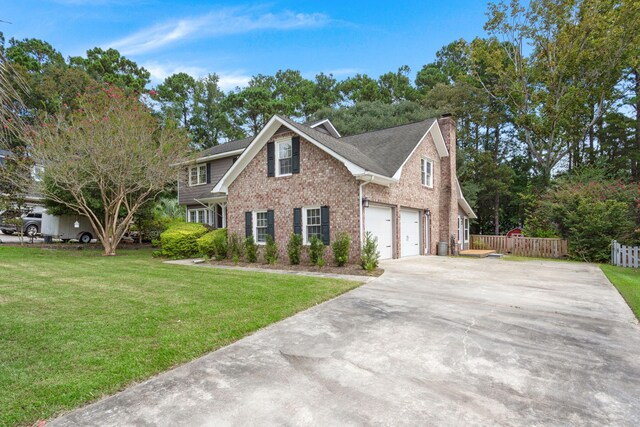 view of front of home with a front lawn and a garage