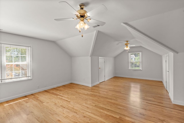 bonus room featuring vaulted ceiling, light wood finished floors, and baseboards