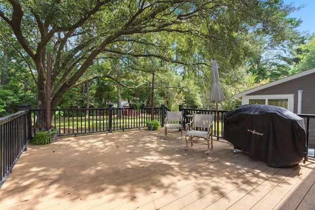 wooden deck featuring area for grilling