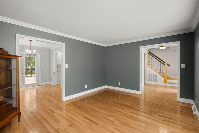 spare room with a notable chandelier, visible vents, stairway, light wood-type flooring, and baseboards