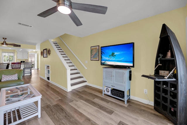 living room with ceiling fan and light wood-type flooring