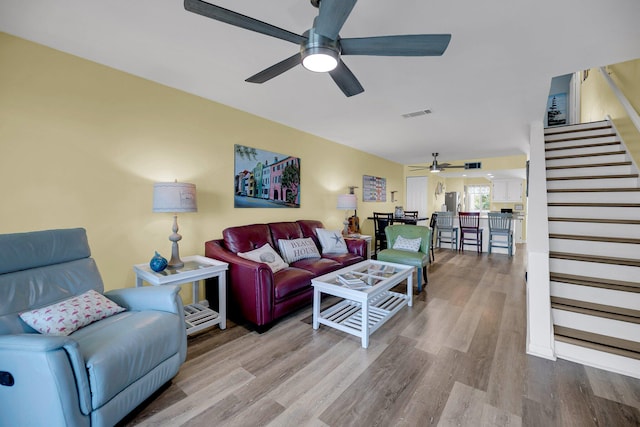 living room with ceiling fan and light hardwood / wood-style floors