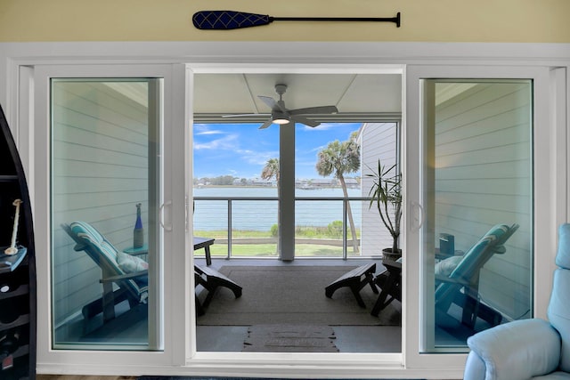 interior space featuring ceiling fan and a water view