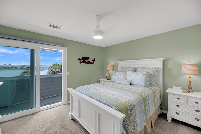 bedroom featuring a water view, ceiling fan, light colored carpet, and access to outside