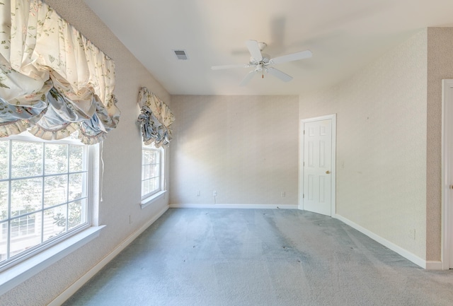 carpeted spare room with ceiling fan