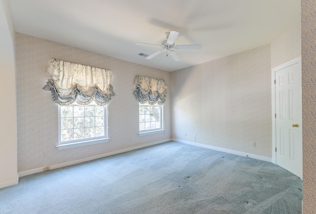 carpeted empty room featuring ceiling fan