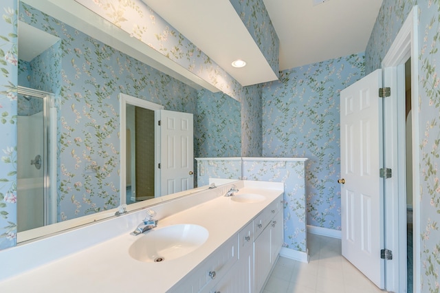 bathroom with tile patterned flooring, an enclosed shower, and vanity