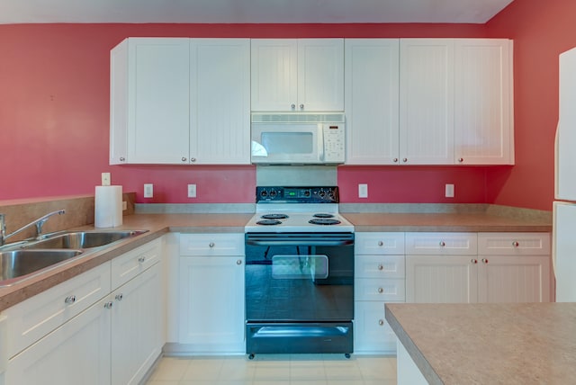 kitchen with white cabinets, sink, and range with electric stovetop