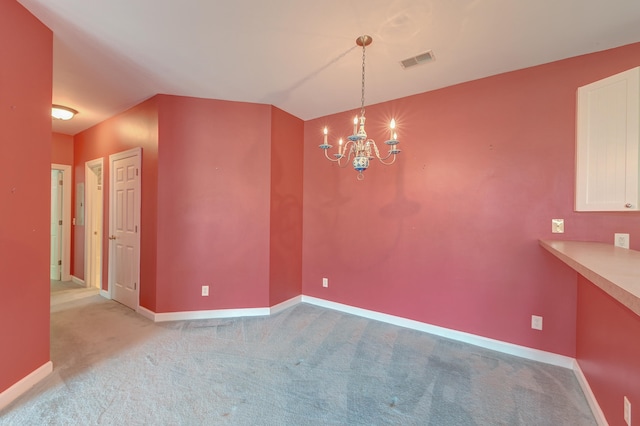 unfurnished dining area featuring light colored carpet and a notable chandelier