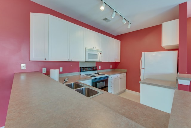 kitchen with rail lighting, white appliances, white cabinetry, and sink