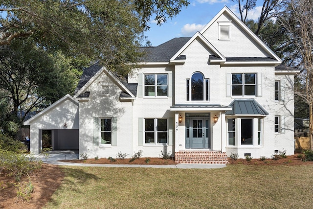 view of front of home featuring crawl space, a standing seam roof, brick siding, and a front yard