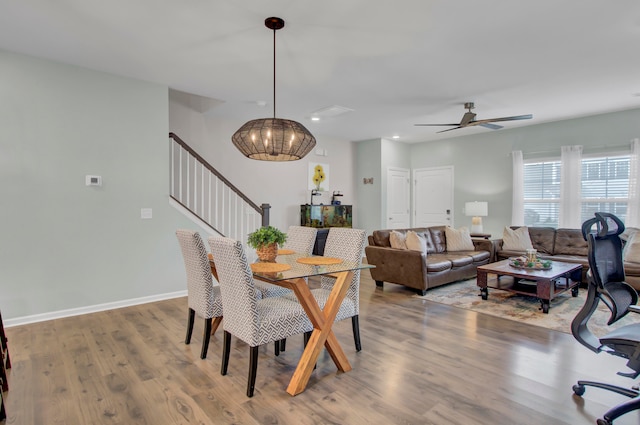 dining space with ceiling fan and hardwood / wood-style flooring