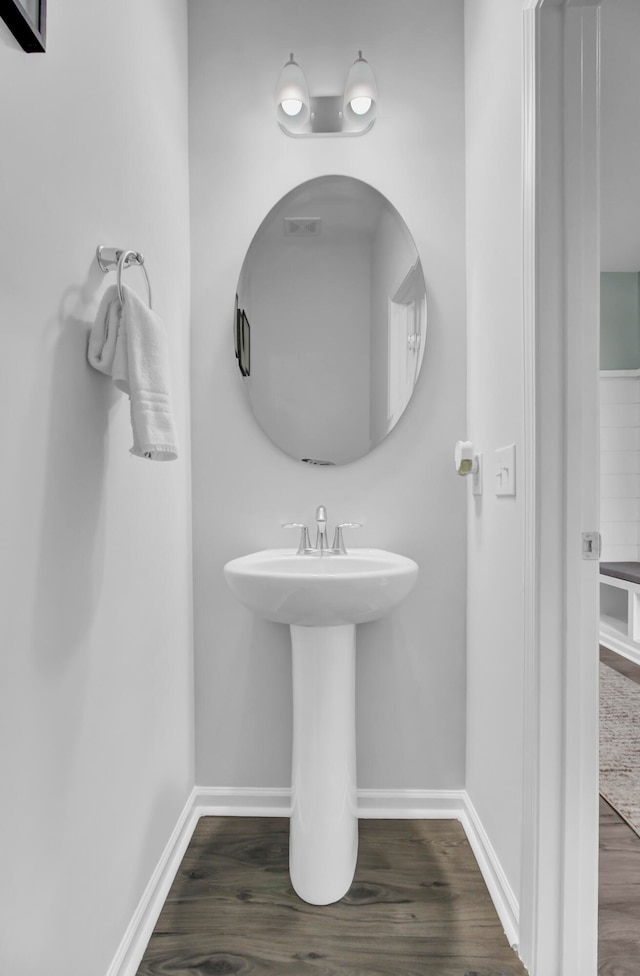 bathroom with hardwood / wood-style floors