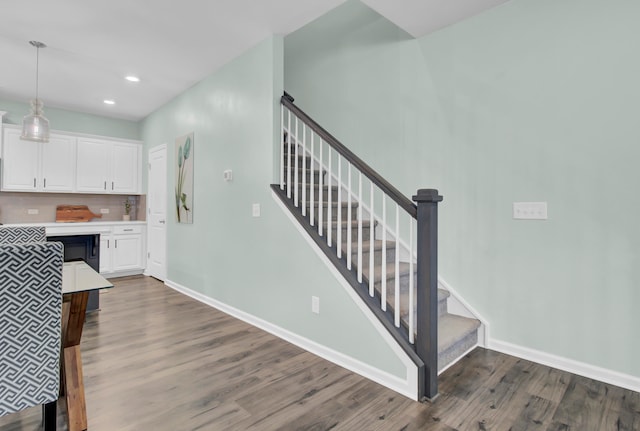 stairs with hardwood / wood-style flooring