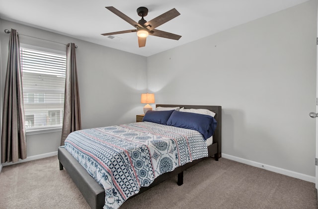 bedroom featuring ceiling fan and light carpet