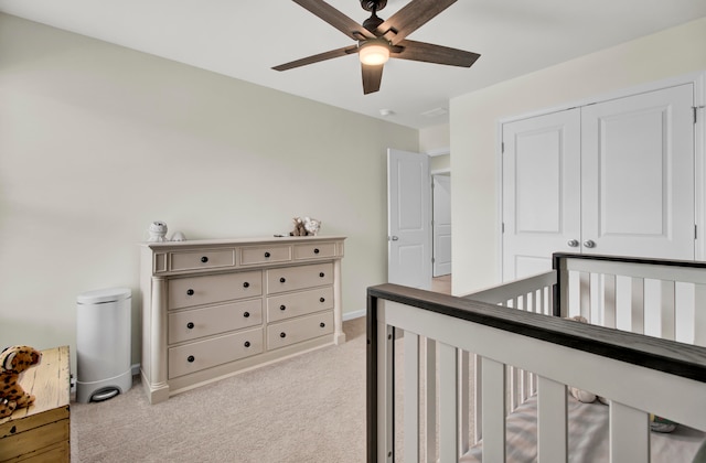 carpeted bedroom with ceiling fan and a closet