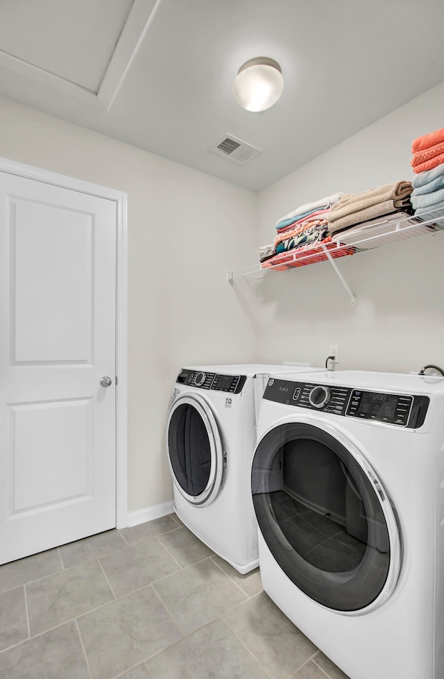 washroom featuring washer and dryer and light tile patterned floors