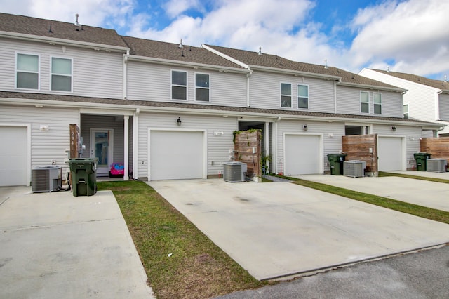 view of front of home featuring central AC unit and a garage