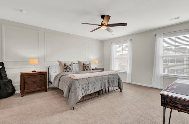 bedroom featuring ceiling fan and light colored carpet