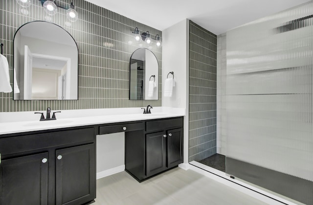 bathroom with walk in shower, vanity, tile patterned floors, and tile walls