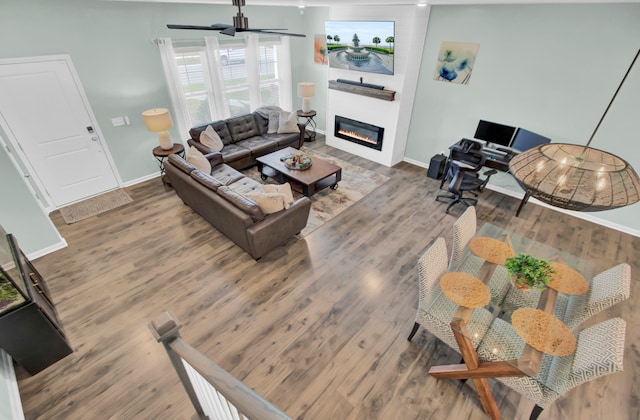 living room featuring hardwood / wood-style floors and ceiling fan