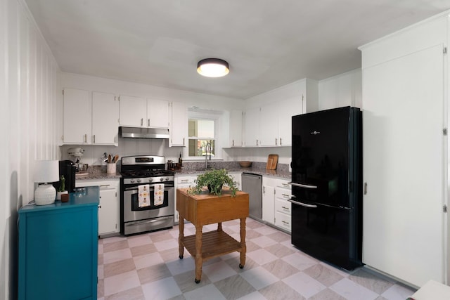 1417 Downing St, Charleston, SC 29407 - kitchen with stainless steel appliances, under cabinet range hood, light floors, and white cabinets