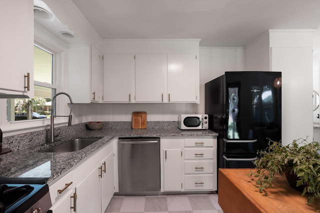 1417 Downing St, Charleston, SC 29407 - kitchen with stainless steel dishwasher, freestanding refrigerator, white microwave, and light stone counters