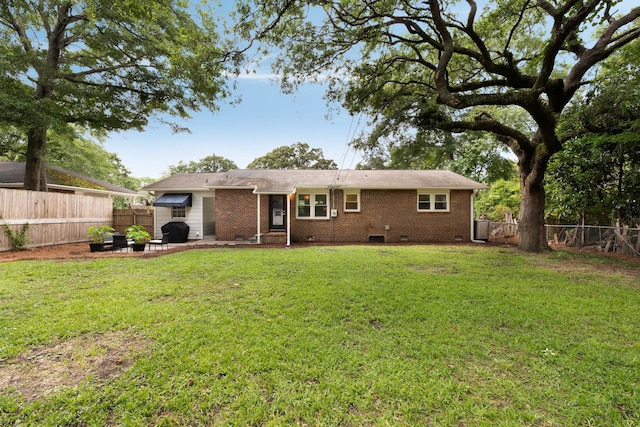 1417 Downing St, Charleston, SC 29407 - back of house featuring a fenced backyard, brick siding, crawl space, and a patio area