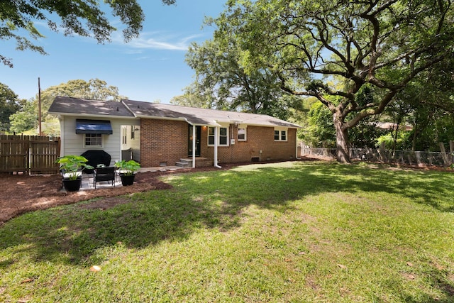 1417 Downing St, Charleston, SC 29407 - back of property featuring brick siding, a fenced backyard, and crawl space