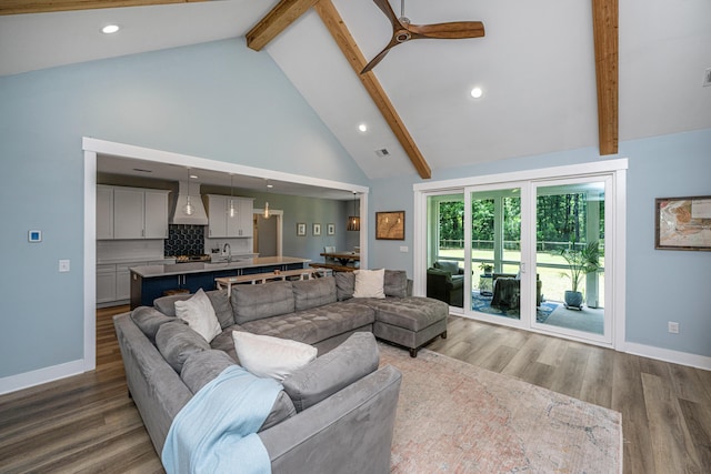 living area featuring beamed ceiling, wood finished floors, high vaulted ceiling, recessed lighting, and baseboards