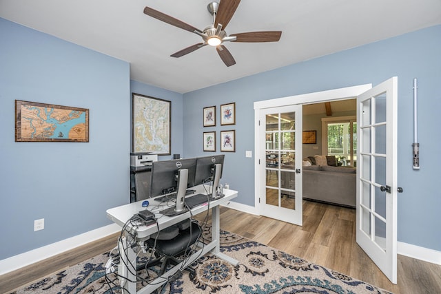 office with french doors, ceiling fan, wood finished floors, and baseboards