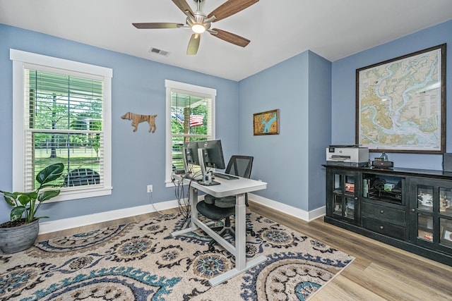 office area featuring wood finished floors, a ceiling fan, and baseboards