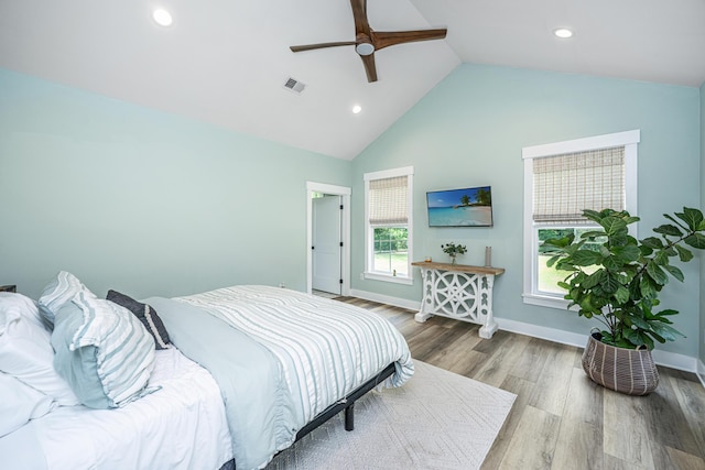bedroom featuring wood finished floors, recessed lighting, a ceiling fan, baseboards, and high vaulted ceiling