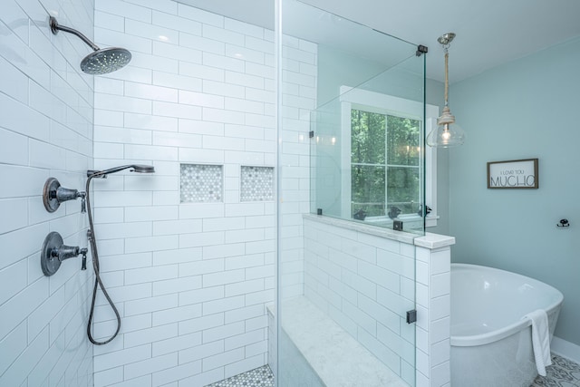 bathroom with tiled shower and a freestanding bath